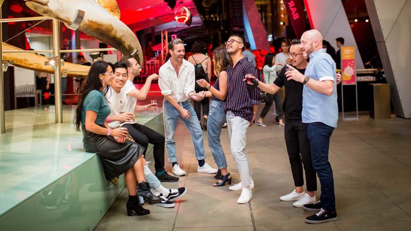 Adult visitors next to the Blue Whale display in the Galleria during Nocturnal at Melbourne Museum