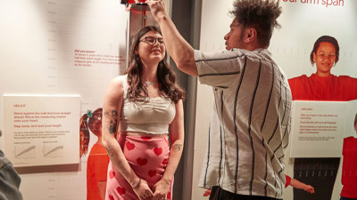 People enjoying the Valentine's Day themed events at Scienceworks, take time to measure heights.