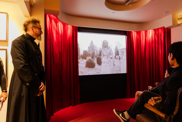 People watching a B-grade horror film in the Haunted Cinema during Halloween at the Museum, Melbourne Museum.