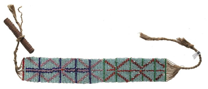 Ornament made with small blue, pink and red beads threaded in geometric patterns, attached to fibre cords and a carved wooden toggle