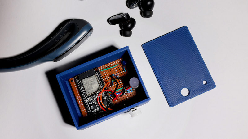 Low, rectangular sideboard in dark-stained timber with four polished-brass disc handles, three storage compartments with sliding doors, and slender squared legs.