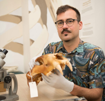 Rohan Long holding an animal skull