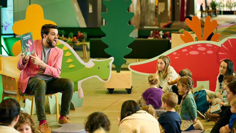 Children being read to at Dino Days.