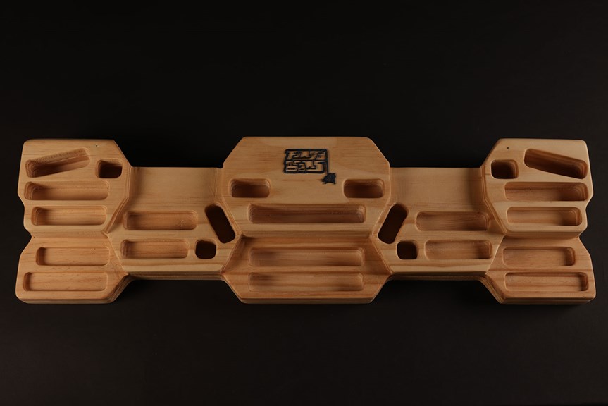 Geometric wooden model with several rectangular recesses.
