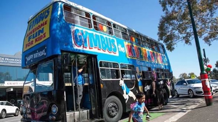 A double decker bus converted to include gymnastic equipment course.