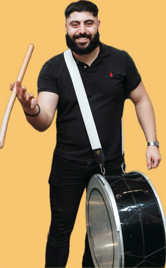 A man with a Lebanese drum twirling a drum stick between his thumb and forefinger.