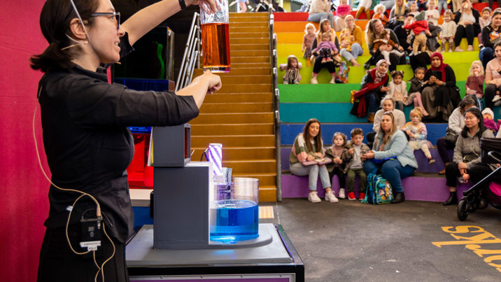  Families watching The Colour Combo Show in the Ampitheatre, during the 'Little Kids day In - Ready, Set, Glow' event at Scienceworks.