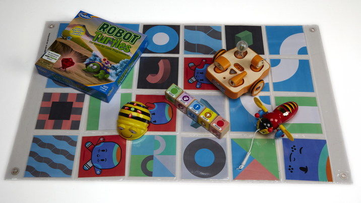 Five different toys on a floor map