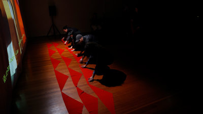 Participants are laying their red ties on the floor.