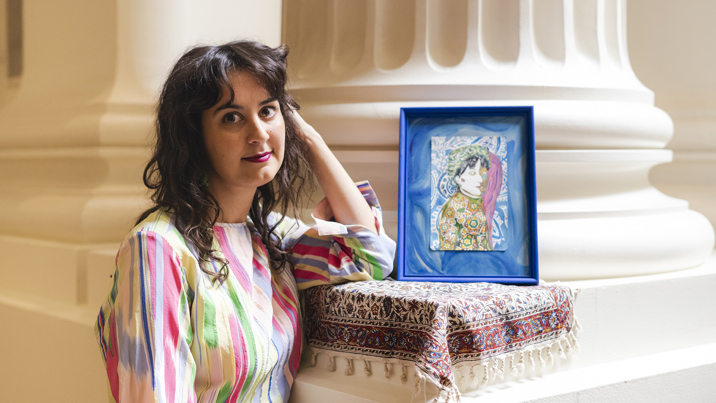 Kate Robinson posing next to her art