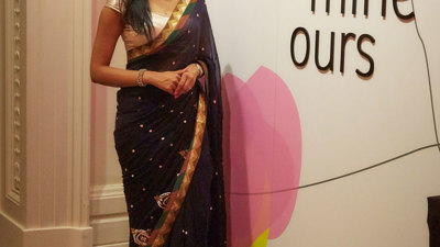 Woman wearing a sari outside the 'Identity: Yours Mine Ours' exhibition during the Diwali Up Late Festival at Immigration Museum