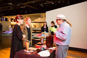 Visitors enjoying the 'expert talk' on objects from the technology collection by Matthew Churchward at Melbourne Museum's December 2017 Nocturnal event.