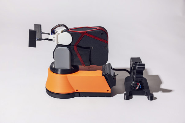 Solar panel mounted on a blue bracket, attached to a grey, cylindrical plastic base.