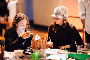 Adults crafting during Nocturnal at Melbourne Museum.