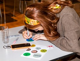 An adult crafting during Nocturnal, Melbourne Museum.