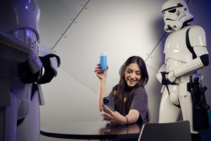 Woman poses for a selfie with blue milk.