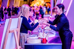 People purchasing cocktails and food from the bar at Nocturnal, Melbourne Museum.