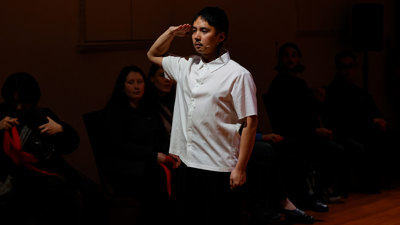 Chung Nguyen in a white shirt is saluting