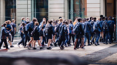 A group of students entering the Immigration Museum from the courtyard.
