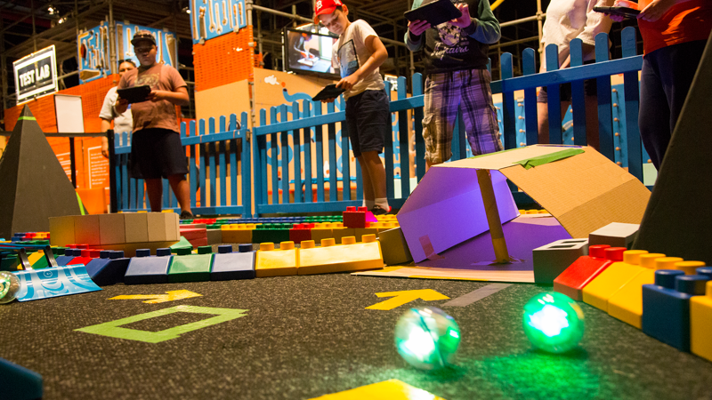 Children navigating their maze using iPads and Shero robots.