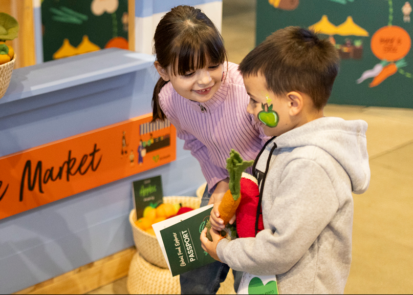 Siblings learning about where food comes from at the Secret World of food display at Scienceworks.