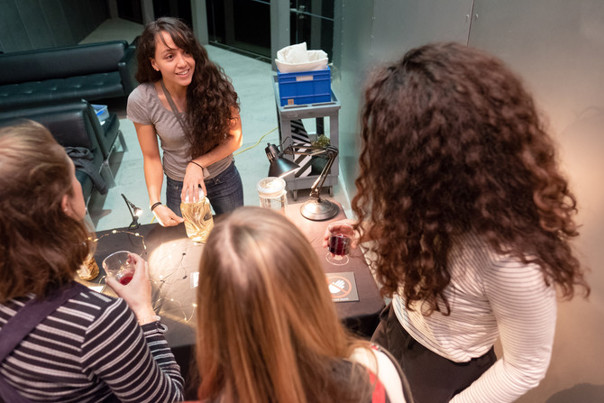 Museum goers drink wine while learning about the Museum's amazing collections.